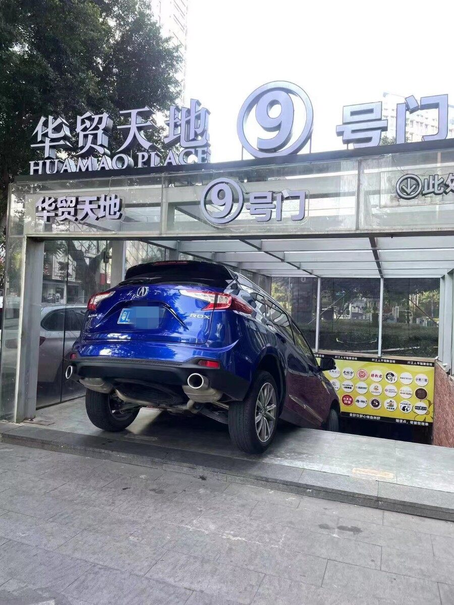 华贸一辆小车开进了9号街大门，卡在台阶上
